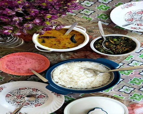 Traditional Bangladeshi meal with rice, dal, and vegetables on a table