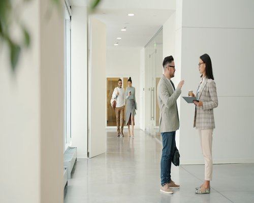 A person taking a short walking break in an office corridor